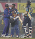 India's captain Rohit Sharma, left, greets Sri Lanka's captain Dasun Shanaka, center, after wining the first one-day international cricket match between India and Sri Lanka in Guwahati, India, Tuesday, Jan. 10, 2023.(AP Photo/Anupam Nath)