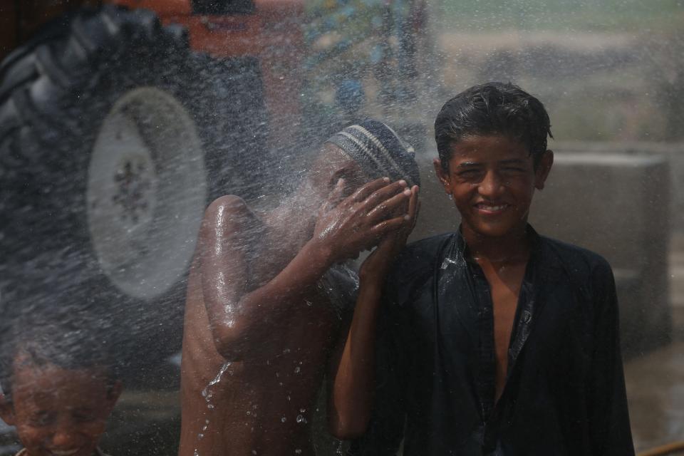 Children cool off in water in Jacobabad, Pakistan.