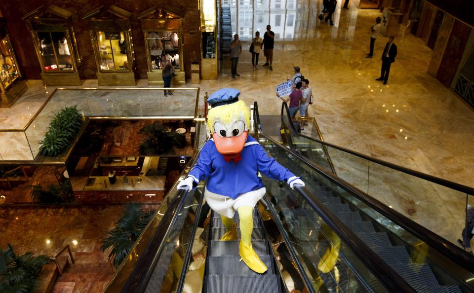 In August 2016, a protester in a Donald Duck costume rides an escalator in the Trump Tower in Manhattan, as part of a political stunt to draw attention to the decision by the Republican presidential candidate not to release his tax returns. (Photo: Justin Lane/Epa/REX/Shutterstock)