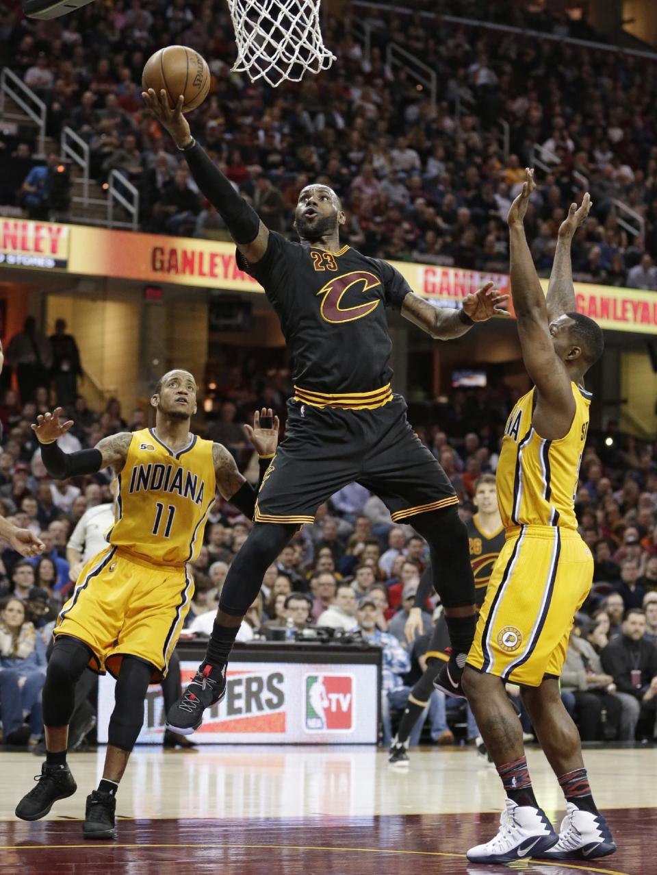 Cleveland Cavaliers' LeBron James (23) drives to the basket against Indiana Pacers' Monta Ellis (11) and Rodney Stuckey (2) in the first half of an NBA basketball game, Wednesday, Feb. 15, 2017, in Cleveland. The Cavaliers won 113-104. (AP Photo/Tony Dejak)