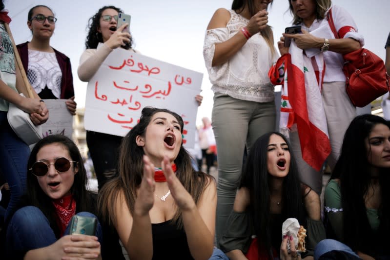 Protesters take part in the ongoing anti-government protests in Beirut