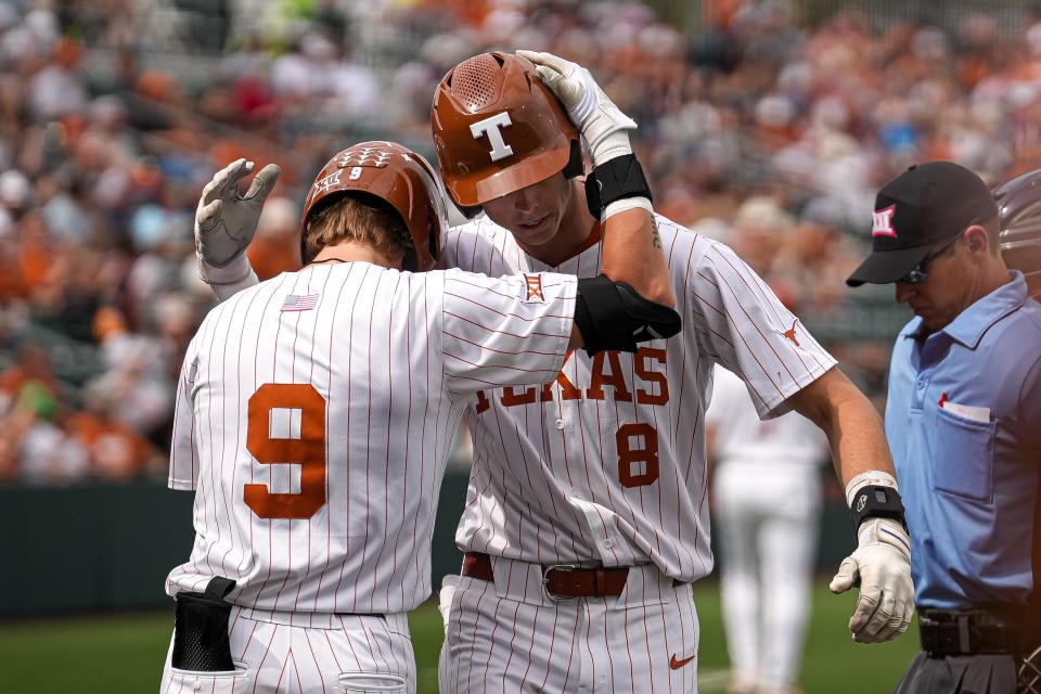 Texas' Jared Thomas greets Will Gasparino after a home run March 16 against Washington. Gasparino's two-run homer in Friday's 6-3 win over Central Florida was the 100th of the season for the Longhorns.