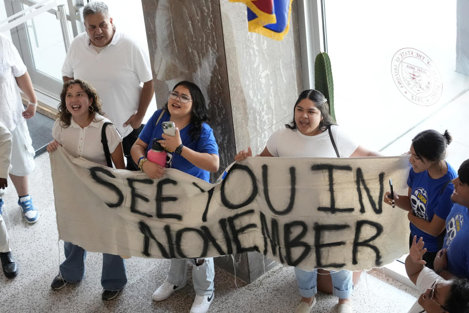 Opponents gather inside the Arizona State Capitol, Tuesday, June 4, 2024, in Phoenix after the Arizona legislature gave final approval to a the proposal that will ask voters to make it a state crime for noncitizens to enter the state through Mexico at any location other than a port of entry. (AP Photo/Matt York)