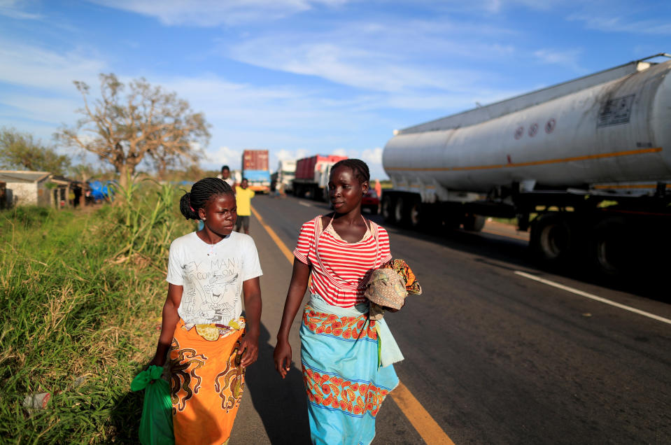 Maria Jofresse, 25, walks with her neighbor near a camp for the displaced in the aftermath of Cyclone Idai, in John Segredo, near Beira, Mozambique April 4, 2019. Maria Jofresse lost her two children to the storm. In the midst of the floods, she dug their small graves but can't find them anymore. "People suffered indeed but no one suffered as I did because I lost the most precious things I had - my kids," she said. (Photo: Zohra Bensemra/Reuters)  