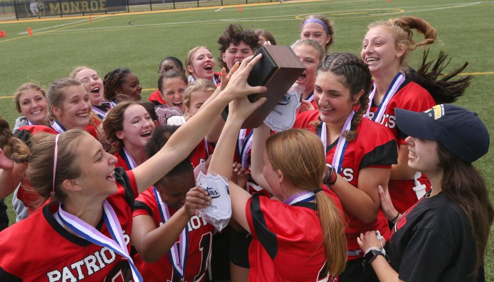 Penfield players celebrate with the first ever flag football Class A sectional Championship block after their win Saturday, June 10, 2023 at Monroe Community College.  Penfield won the game 31-6 over Webster Thomas.