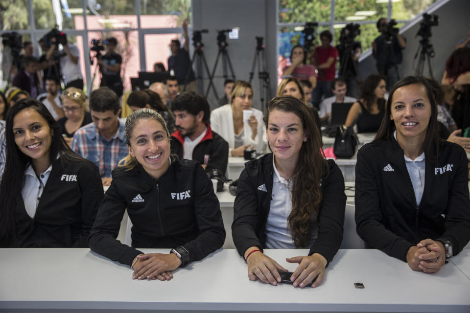 Female referees attend a press conference to announce the early implementation of a plan to professionalize women's soccer in Buenos Aires, Argentina, Saturday, March 16, 2019. Almost 90 years after men's soccer turned professional in Argentina, the women's game is still being played by amateur athletes who get little to no money for their work on the field. (AP Photo/Daniel Jayo)