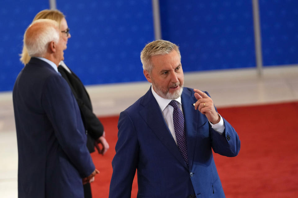 Italy's Defense Minister Lorenzo Guerini, right, speaks with the media as he arrives for a meeting of EU Defense Ministers at the Prague Congress Center in Prague, Czech Republic, Tuesday, Aug. 30, 2022. (AP Photo/Petr David Josek)