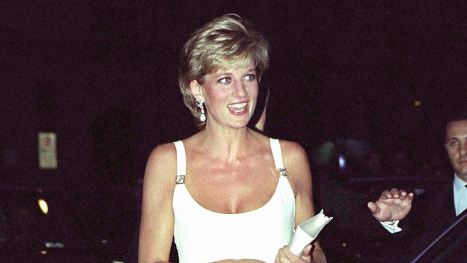 Princess Diana Attending A Concert In Italy In Aid Of Bosnian Children. The Princess Is Wearing A Short White Dress And White Shoes