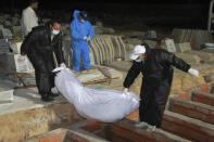 FILE - In this June 11, 2020 file photo, a migrant is buried in a cemetery, in Sfax, eastern Tunisia. The number of Tunisians migrating clandestinely to Italy has risen to levels not seen since the 2011 Arab Spring uprising. That's causing tensions in Italy's south, where more than 2,200 migrants are quarantining on ferries anchored offshore. (AP Photo/Houssem Zouari, File)