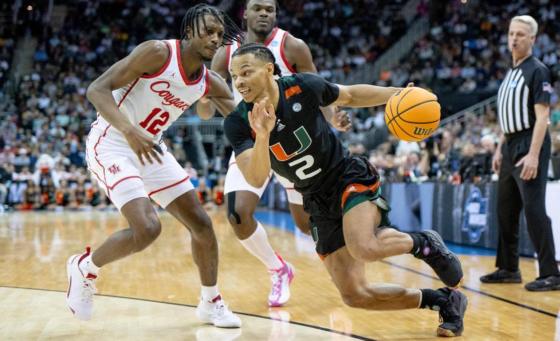 Miami guard Isaiah Wong (2) drives against Houston guard Tramon Mark (12) during a Sweet 16 college basketball game in the Midwest Regional of the NCAA Tournament Friday, March 24, 2023, in Kansas City.