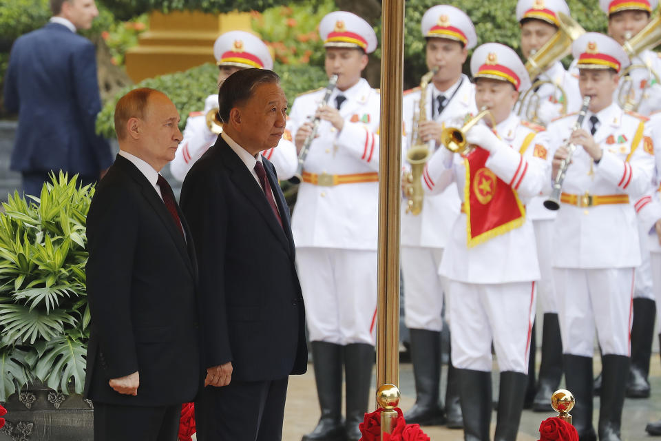 Vietnamese President To Lam, right, and his Russian counterpart Vladimir Putin review the guard of honor at the Presidential Palace in Hanoi, Vietnam, Thursday, June 20, 2024. (AP Photo/Minh Hoang)