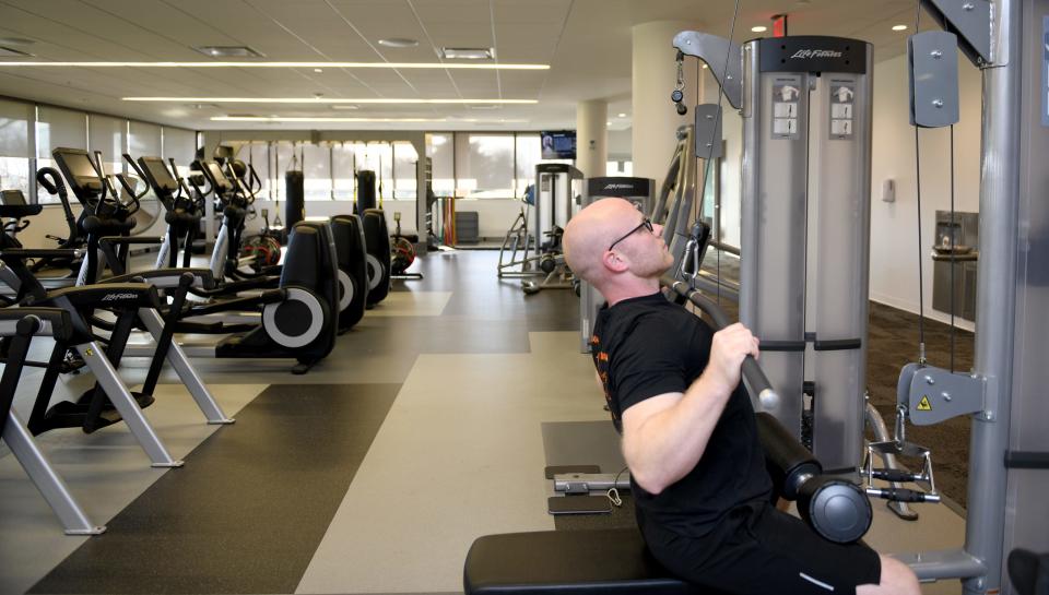 Andy Kessler, fitness center manager at the Timken Co. world headquarters in Jackson Township, shows off the available equipment for employees to use. Like many businesses, Timken has more open jobs than it can fill.