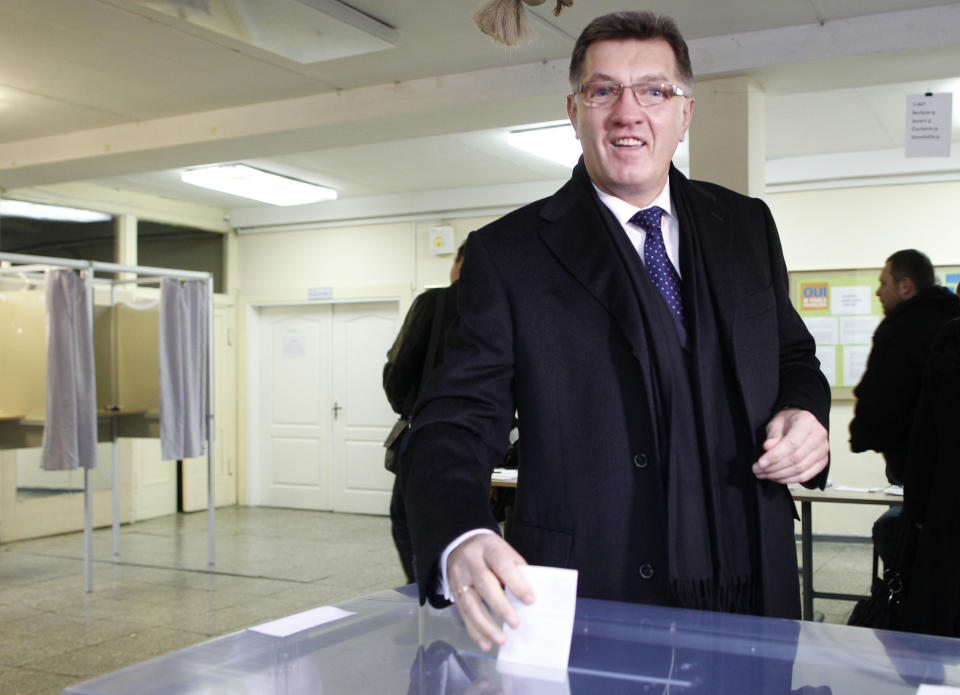 Social Democrat party leader Algirdas Butkevicius casts his vote at a polling station in Vilnius, Lithuania, Sunday, Oct. 28, 2012. Lithuanians balloted Sunday in a second - round of parliamentary elections. (AP Photo/Mindaugas Kulbis)