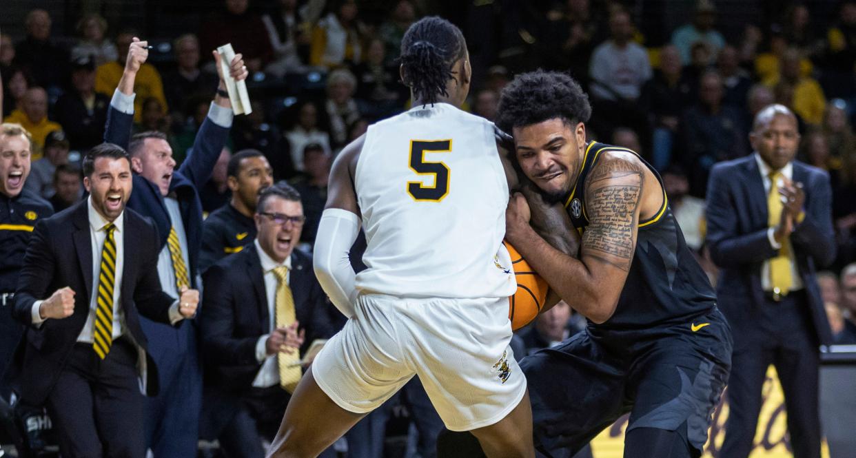 Missouri's Ronnie DeGray III, right, gets locked up with Wichita State's Jaron Pierre Jr. during the first half of an NCAA college basketball game Tuesday, Nov. 29, 2022, in Wichita, Kan.