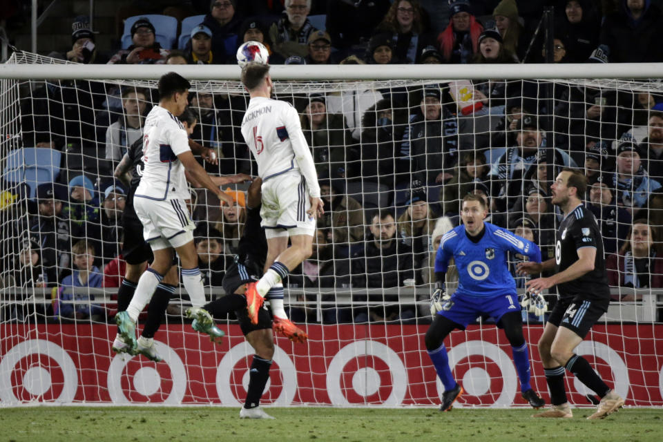 Minnesota United goalkeeper Clint Irwin (1) watches at Vancouver Whitecaps defender Tristan Blackmon (6) heads the ball in the second half of an MLS soccer game Saturday, March 25, 2023, in St. Paul, Minn. (AP Photo/Andy Clayton-King)