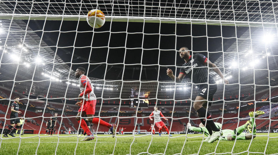 Young Boys' Jordan Siebatcheu, left, scores his side's opening goal during the Europa League round of 32, 2nd leg soccer match between Bayer 04 Leverkusen and Young Boys Bern in Leverkusen, Germany, Thursday, Feb. 25, 2021. (AP Photo/Martin Meissner, POOL)