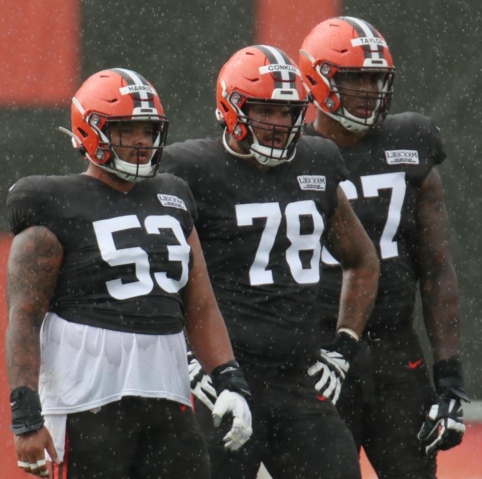Center Nick Harris, tackle Jack Conklin and tackle Alex Taylor watch during team practice at the Browns training facility in Berea on on Monday Aug. 17, 2020.