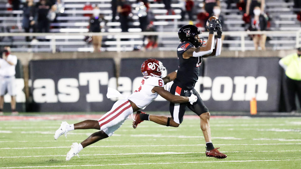 Texas Tech wide receiver Erik Ezukanma makes a reception while covered by Oklahoma cornerback Tre Brown in the first half of an NCAA college football game, Saturday, Oct. 31, 2020, in Lubbock, Texas. (AP Photo/Mark Rogers)