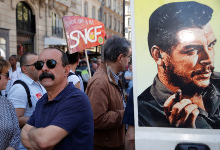 French CGT labour union leader Philippe Martinez stands next to an image of revolutionary hero Ernesto "Che" Guevara during a demonstration against the French government's reform plans in Paris as part of a national day of protest, France, April 19, 2018. REUTERS/Philippe Wojazer