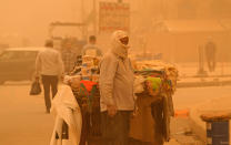 A street vendor waits for customers during a sandstorm in Baghdad, Iraq, Monday, May 16, 2022. (AP Photo/Hadi Mizban)