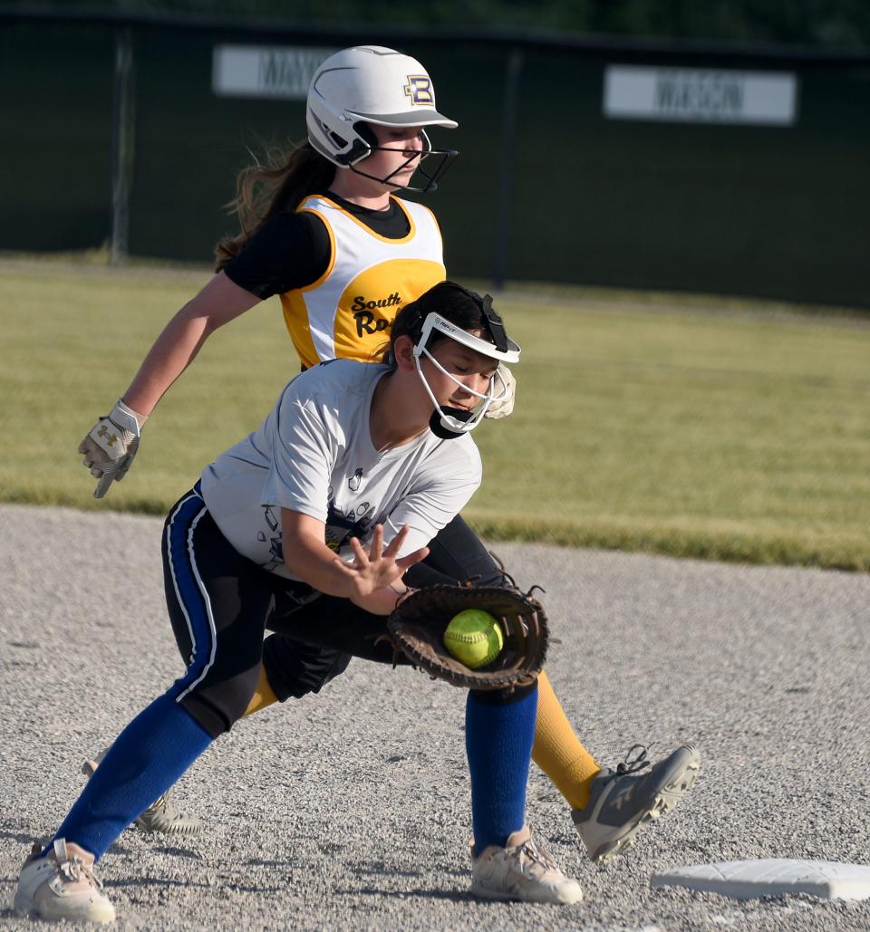 Ida first baseman Aubrey Vogt takes the throw as Braelyn Runyon of South Rockwood gets back to the bag during last year's Monroe County Fair Softball Tournament.