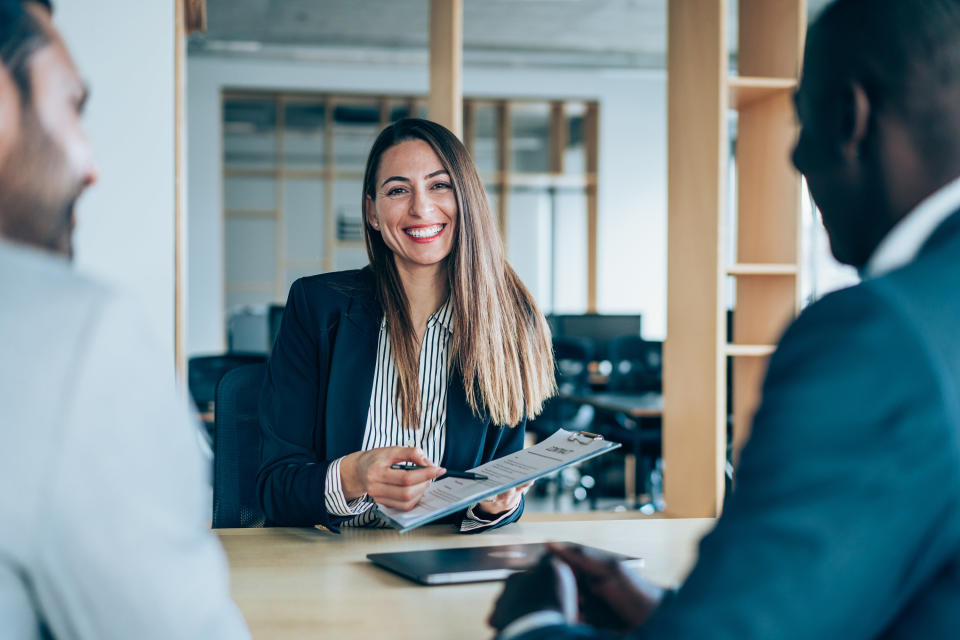 Woman talking with two men in an office