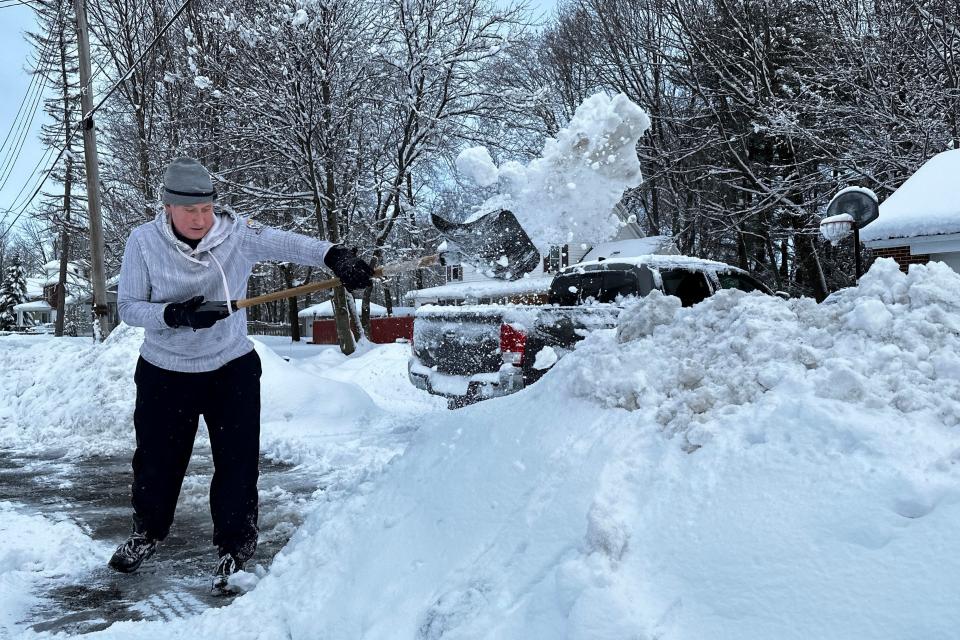 Michael Barbieri, 52, shovels snow from his driveway and sidewalk before going to work, Wednesday, March 15, 2023, in Pittsfield, Mass. The storm dumped heavy, wet snow on parts of the Northeast, causing tens of thousands of power outages.