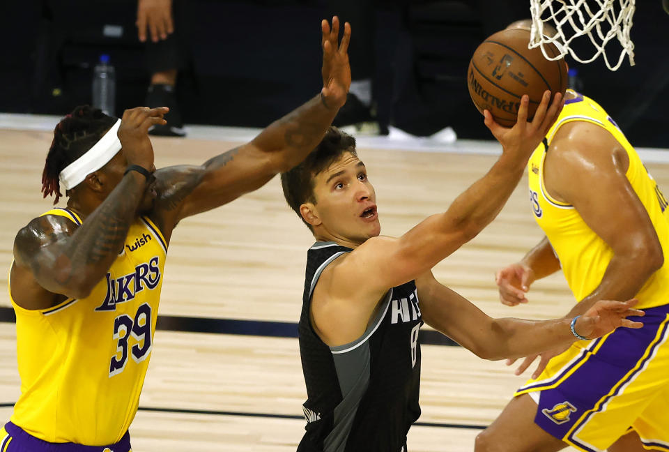 Sacramento Kings' Bogdan Bogdanovic (8) goes up for a shot against Los Angeles Lakers' Dwight Howard (39) during the second quarter of an NBA basketball game Thursday, Aug. 13, 2020, in Lake Buena Vista, Fla. (Kevin C. Cox/Pool Photo via AP)