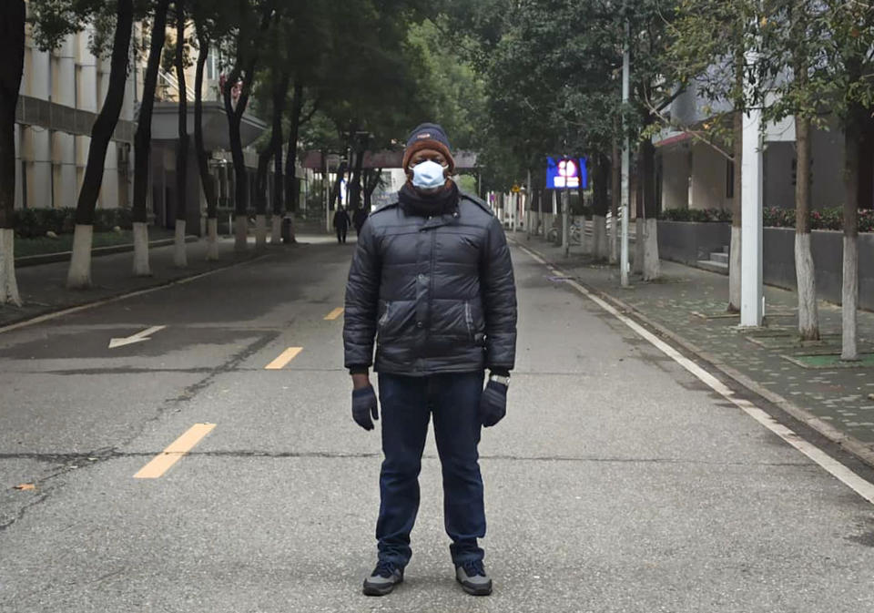 This Jan. 27, 2020, photo, provided by Dr. Khamis Hassan Bakari of Tanzania, shows him posing for a photo in Wuhan, China. Bakari is among more than 4,000 African students in the Chinese city of 11 million people, and has been sending updates on social media about the outbreak of a new virus to the more than 400 other Tanzanian students in Wuhan, as China’s astonishing lockdown of more than 30 million people continues. (Khamis Hassan Bakari via AP)