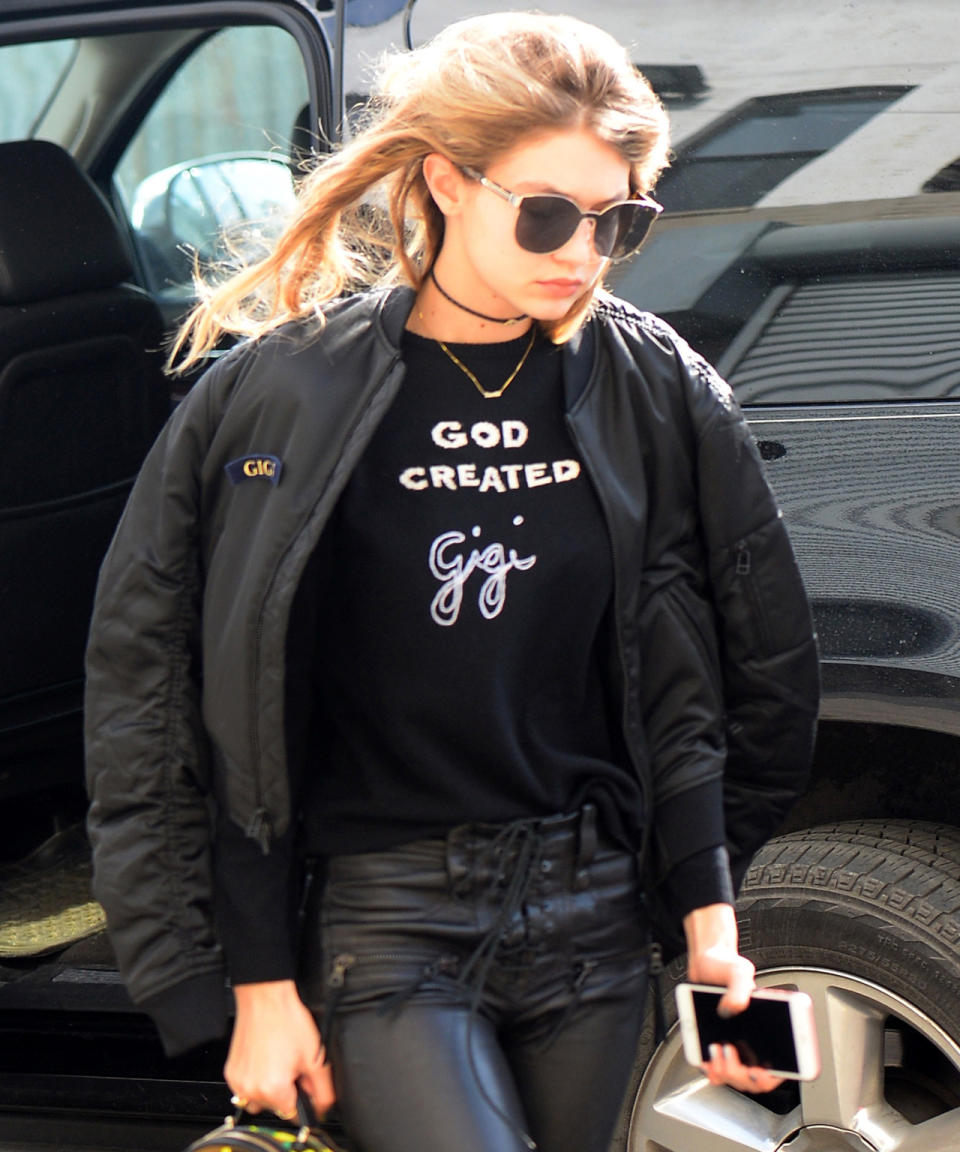 The self-referential queen strikes once more. This time, she doubled up on personalized items: her tee reads “God created Gigi,” while her bomber jacket also bears a “GIGI” label.