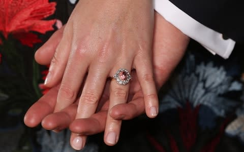 Princess Eugenie wears a ring containing a padparadscha sapphire surrounded by diamonds  - Credit: Jonathan Brady /PA