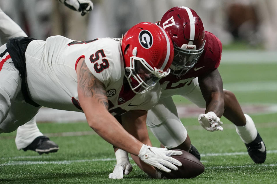 Alabama linebacker Trezmen Marshall (17) recovers a fumble against Georgia offensive lineman Dylan Fairchild (53) during the second half of the Southeastern Conference championship NCAA college football game in Atlanta, Saturday, Dec. 2, 2023. (AP Photo/Mike Stewart)