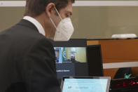 Cooper Offenbecher, left, an attorney for NFL football cornerback Richard Sherman, appears in a district court hearing at the King County Correctional Facility, Thursday, July 15, 2021, in Seattle as Judge Fa'amomoi Masaniai appears on a video link. Sherman, who has played for the Seattle Seahawks and the San Francisco 49ers, was arrested early Wednesday after police said he crashed his car in a construction zone and then tried to break into his in-laws' home in the Seattle suburb of Redmond, Wash. (AP Photo/Ted S. Warren)