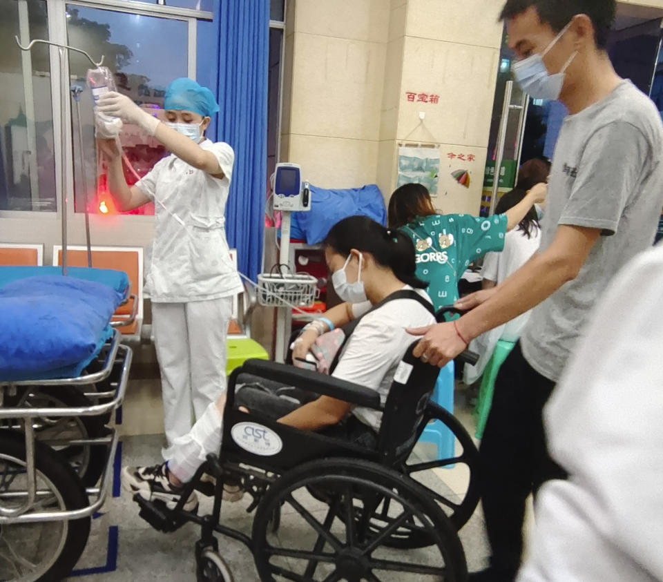 In this photo released by Xinhua News Agency, residents injured in the aftermath of an earthquake get treated at the Luxian People's Hospital in Luxian County, southwest China's Sichuan Province, Thursday, Sept. 16, 2021. An earthquake collapsed homes, killed some and injured others Thursday in southwest China's Sichuan province, state media reported. (Gu Youcong/Xinhua via AP)