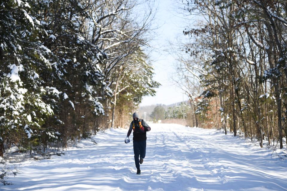 A runner braves a trail at North Boundary Greenway in Oak Ridge, Saturday, Jan. 20, 2024.