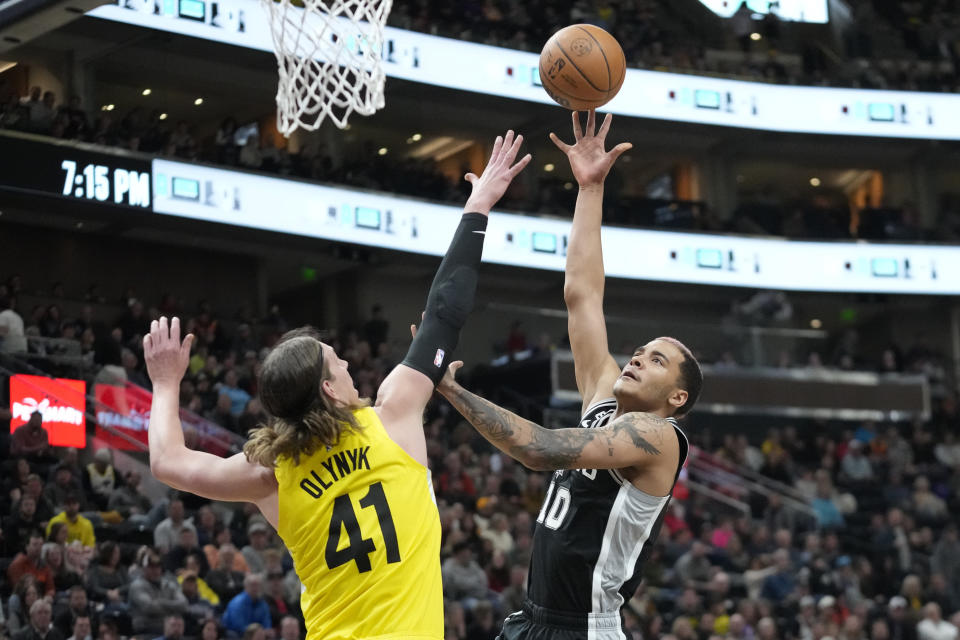 San Antonio Spurs forward Jeremy Sochan (10) shoots as Utah Jazz forward Kelly Olynyk (41) defends during the first half of an NBA basketball game Tuesday, Feb. 28, 2023, in Salt Lake City. (AP Photo/Rick Bowmer)