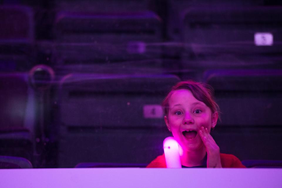 A child watches from the stands during a group wedding ceremony on the ice at the Budweiser Events Center on Feb. 14, 2023 in Loveland, Colo. 12 couples got married during the Valentine's Day event, with more renewing their vows.