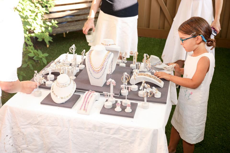 <h1 class="title">A young partygoer admires the jewelry.</h1><cite class="credit">Photo: Matteo Prandoni / BFA.com</cite>