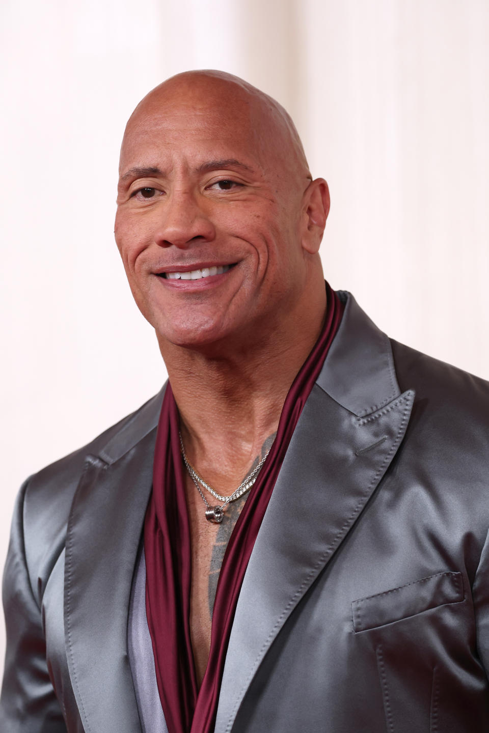 Dwayne Johnson in a silk lapel jacket and deep V-neck top at an event