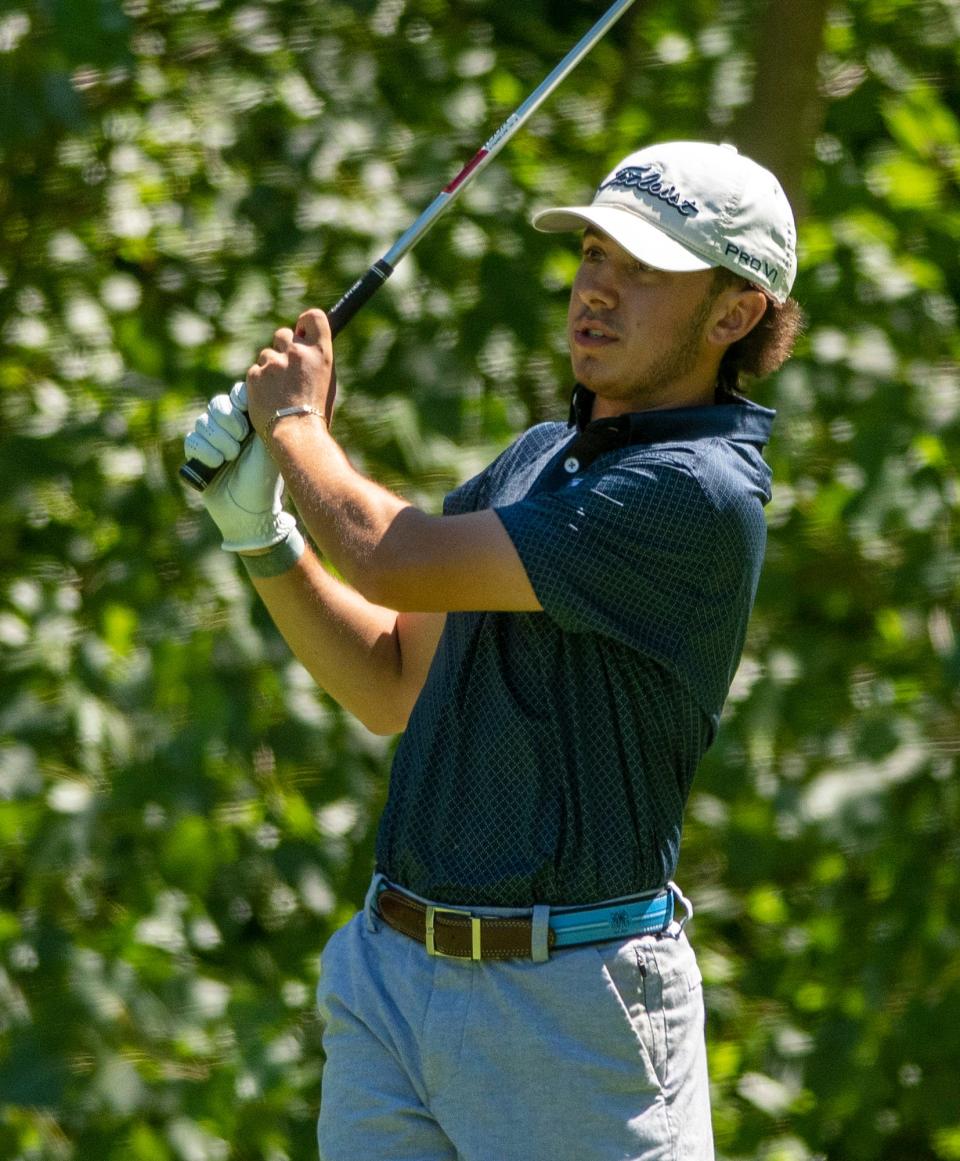 Sean Magarian watches his shot on the 14th tee Sunday during the Worcester County Amateur golf tournament at Wachusett Country Club.