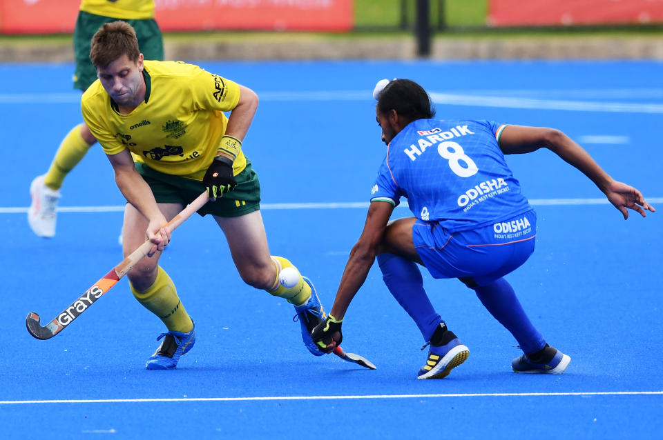 ADELAIDE, AUSTRALIA - NOVEMBER 27: Eddie Ockenden captain of the Kookaburras  competes with Hardik Singh of India during game 2 of the International Hockey Test Series between Australia and India at MATE Stadium on November 27, 2022 in Adelaide, Australia. (Photo by Mark Brake/Getty Images for Hockey Australia)