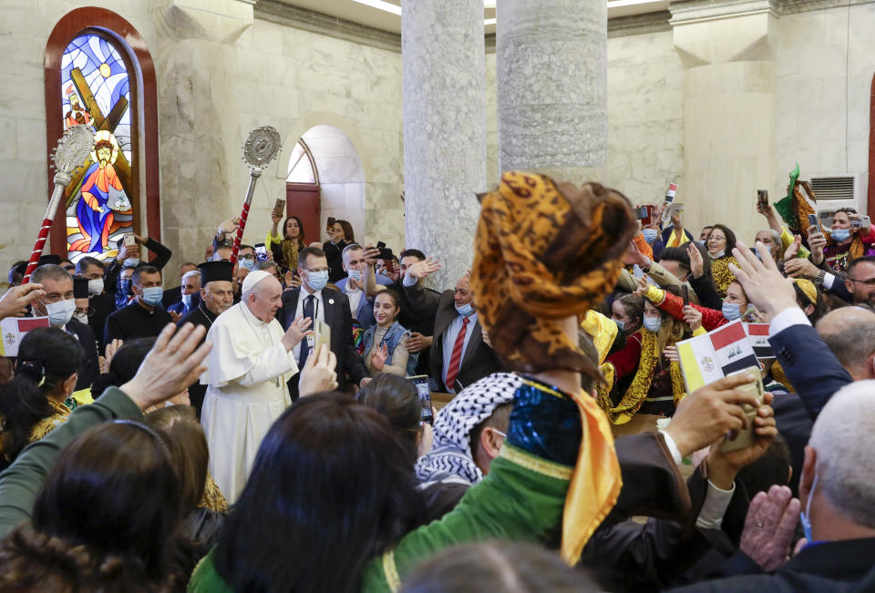 Pope Francis arrives at a meeting with the Qaraqosh community at the Church of the Immaculate Conception, in Qaraqosh, Iraq, Sunday, March 7, 2021. A small Christian community returned to Qaraqosh after the war where they rebuilt their church that had been used as a firing range by IS. (AP Photo/Andrew Medichini)