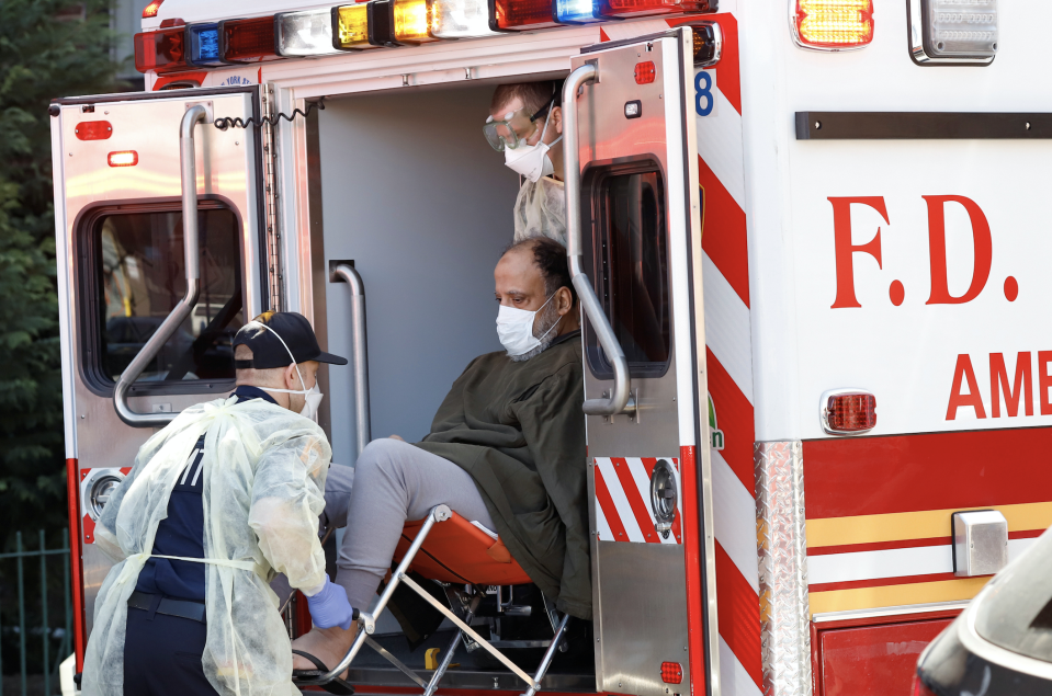 FDNY Emergency Medical Technicians (EMT) lift a patient that was identified to have coronavirus disease (COVID-19) into an ambulance while wearing protective gear, as the outbreak of coronavirus disease (COVID-19) continues, in New York City, New York, U.S., March 24, 2020. (Photo: REUTERS/Stefan Jeremiah)