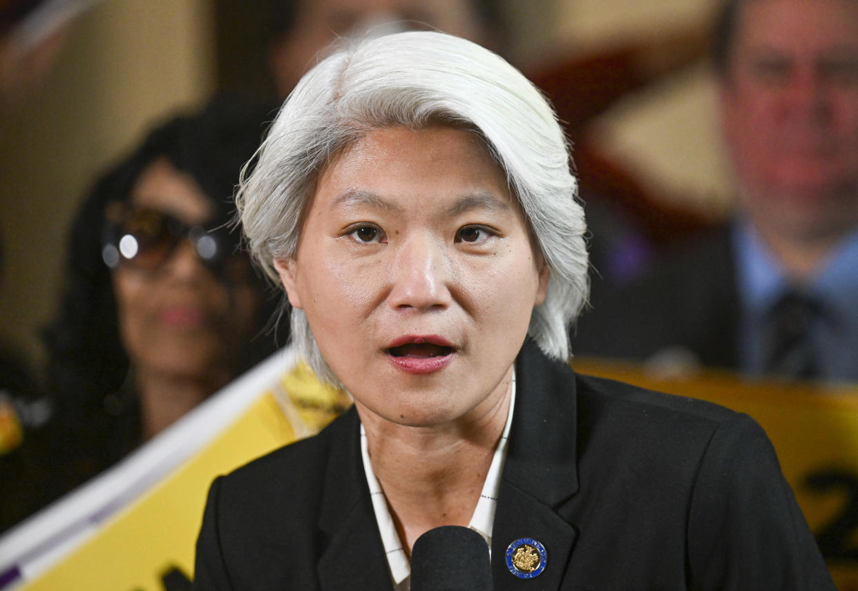 New York Sen. Iwen Chu, D-New York, stands with protesters urging lawmakers to raise New York's minimum wage during a rally at the state Capitol, Monday, March 13, 2023, in Albany, N.Y. (AP Photo/Hans Pennink)