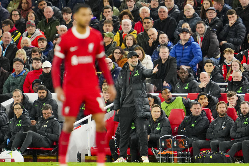 Liverpool's manager Jurgen Klopp, back, gestures during the Europa League quarter final first leg soccer match between Liverpool and Atalanta, at the Anfield stadium in Liverpool, England, Thursday, April 11, 2024. (AP Photo/Jon Super)