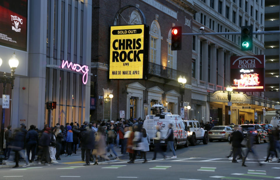 The marquee advertises Chris Rock as ticket holders wait to enter outside the Wilbur Theatre, Wednesday, March 30, 2022, in Boston. (AP Photo/Mary Schwalm)