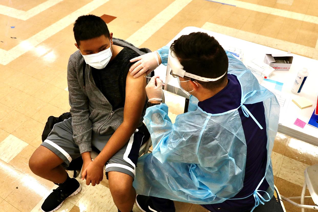 A student receives a dose of the COVID-19 vaccine.