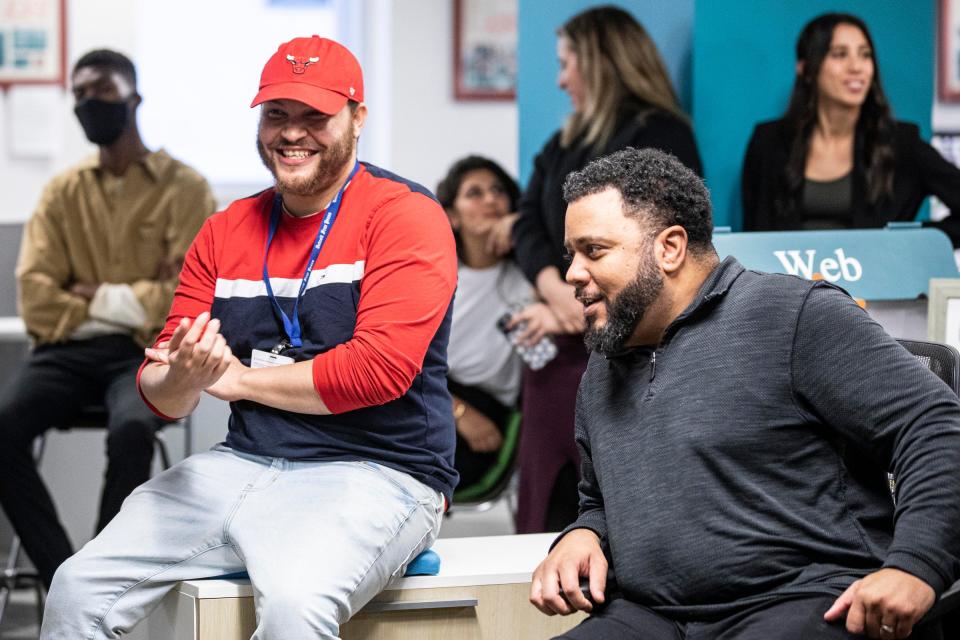 Tyler Davis, assistant sports editor, center, laughs with sports editor Kirkland Crawford during a farewell party at the Detroit Free Press newsroom in Detroit on Jan. 17, 2023.