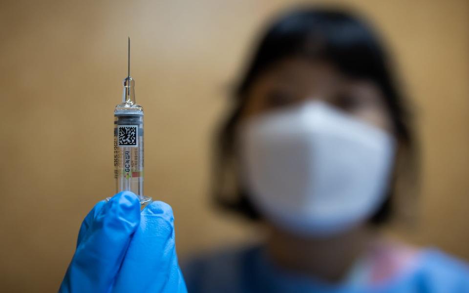 A nurse holds a flu shot vaccine at Gospel Ilsan Hospital in Goyang, South Korea - SeongJoon Cho /Bloomberg 