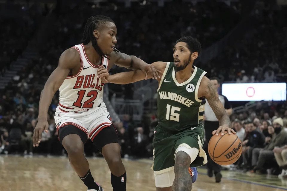 Milwaukee Bucks' Cameron Payne tries to get past Chicago Bulls' Ayo Dosunmu during the first half of an NBA basketball game Monday, Dec. 11, 2023, in Milwaukee. (AP Photo/Morry Gash)